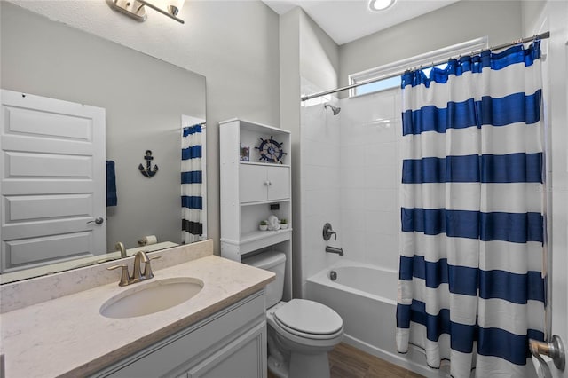 full bathroom featuring toilet, vanity, hardwood / wood-style flooring, and shower / tub combo with curtain