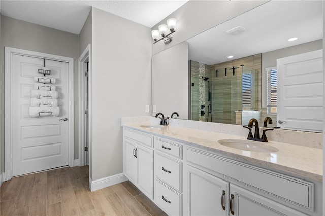 bathroom featuring vanity and a shower with door