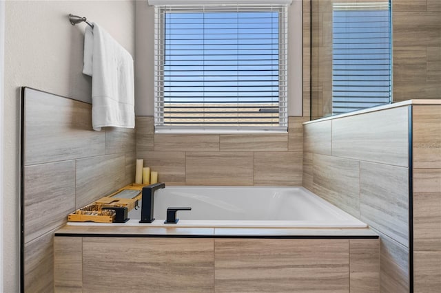 bathroom with a wealth of natural light and tiled tub