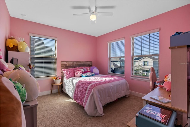 carpeted bedroom with multiple windows and ceiling fan