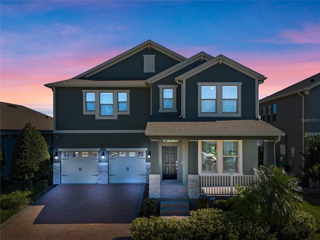 craftsman-style home featuring a porch and a garage