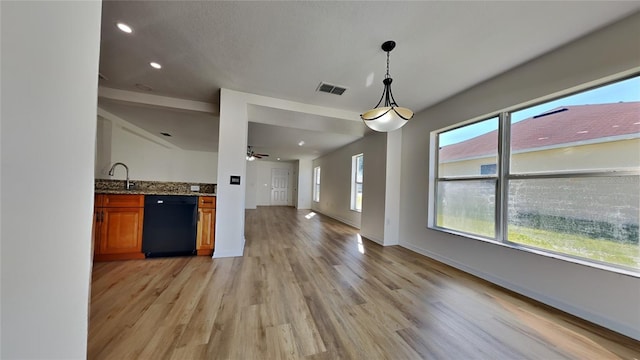 kitchen with ceiling fan, dishwasher, sink, light hardwood / wood-style flooring, and decorative light fixtures