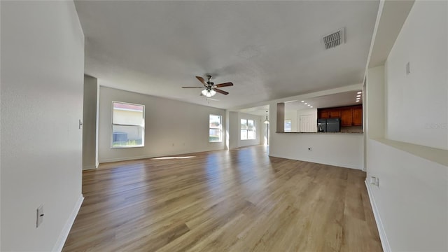 unfurnished living room featuring light hardwood / wood-style floors and ceiling fan