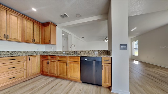 kitchen with ceiling fan, sink, black dishwasher, light stone counters, and light wood-type flooring