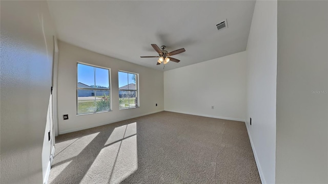 spare room with ceiling fan and light colored carpet