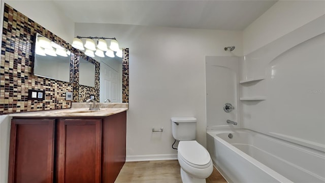 full bathroom featuring decorative backsplash, bathtub / shower combination, vanity, hardwood / wood-style floors, and toilet