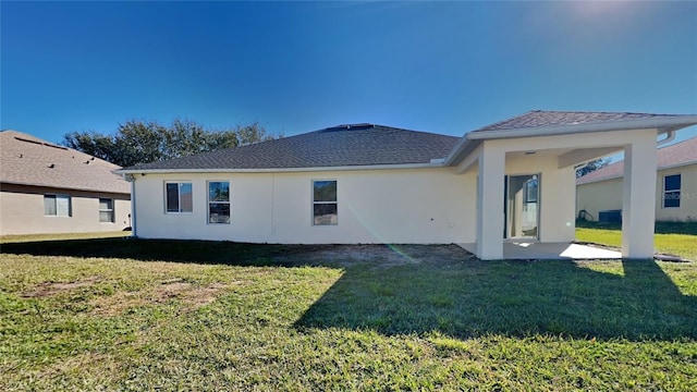 back of property featuring a yard and a patio