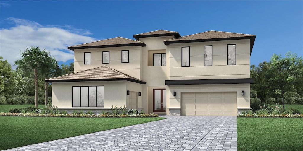 view of front of home featuring a front lawn and a garage