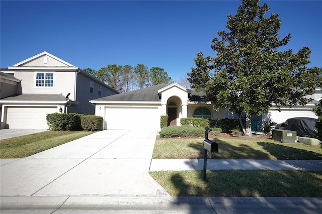 view of front facade featuring a garage and a front lawn