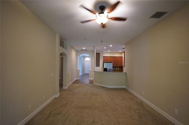 kitchen with light carpet, stainless steel fridge with ice dispenser, decorative backsplash, and ceiling fan