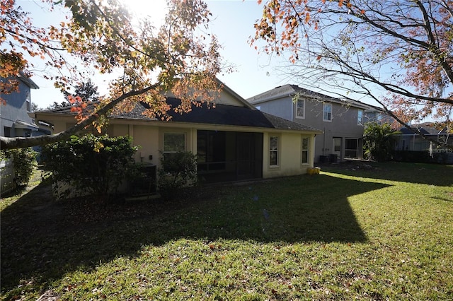 rear view of house with a yard