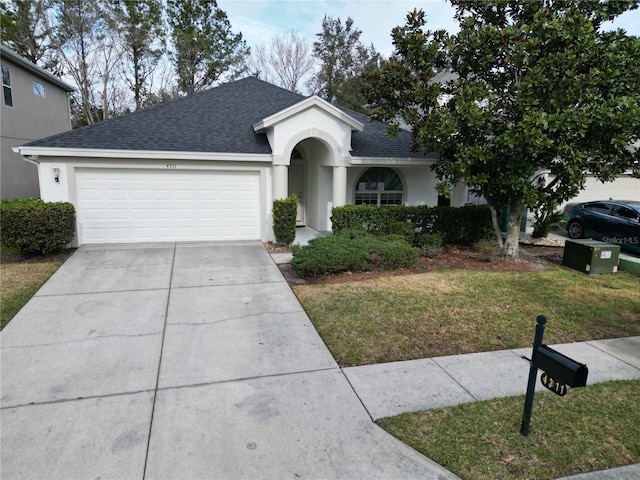 ranch-style house featuring a garage and a front yard