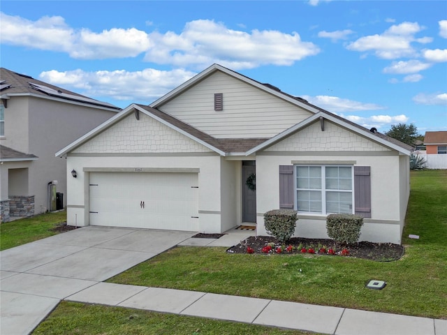 view of front of home featuring a front lawn and a garage