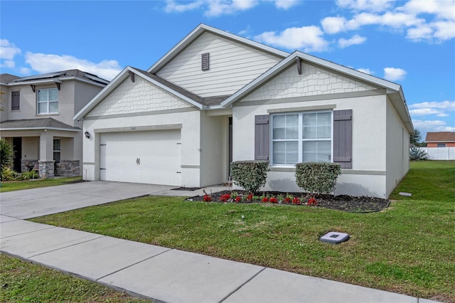 view of front of property featuring a front yard and a garage