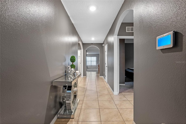 hallway with light tile patterned floors