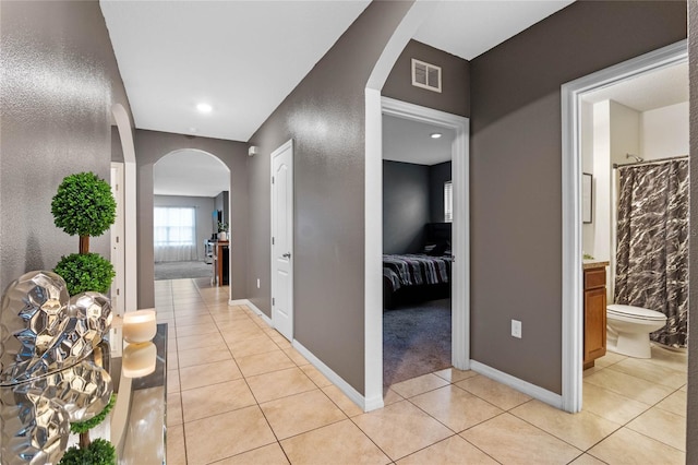 hall featuring light tile patterned floors