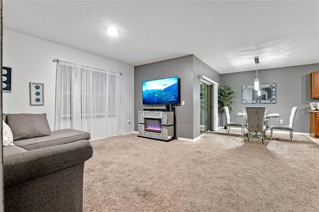 living room featuring a textured ceiling and carpet floors