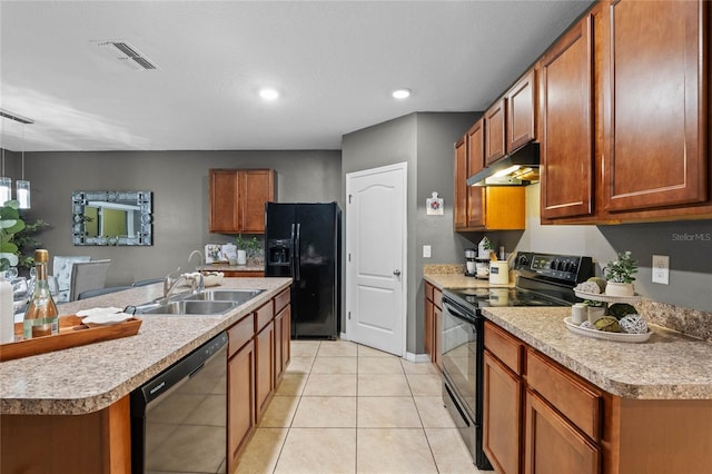 kitchen with black appliances, a center island with sink, sink, and light tile patterned floors