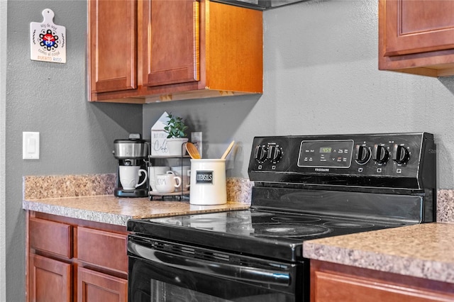 kitchen featuring black range with electric cooktop