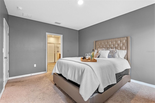 carpeted bedroom with ensuite bathroom