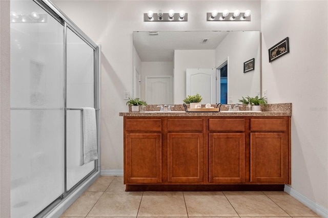 bathroom with vanity, walk in shower, and tile patterned flooring