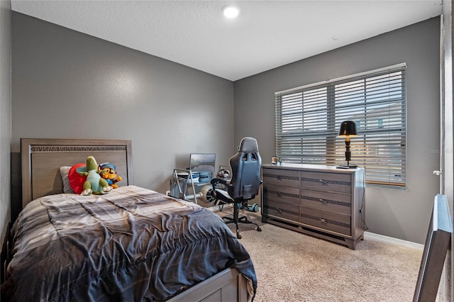 carpeted bedroom with a textured ceiling