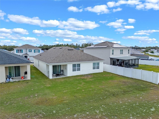 rear view of property with a yard and a patio area