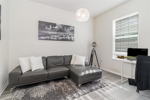 living room featuring a wealth of natural light and wood-type flooring