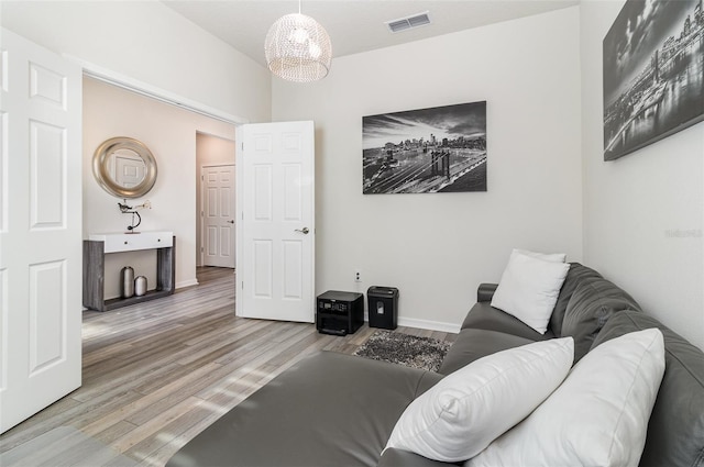 living room featuring hardwood / wood-style flooring and a notable chandelier