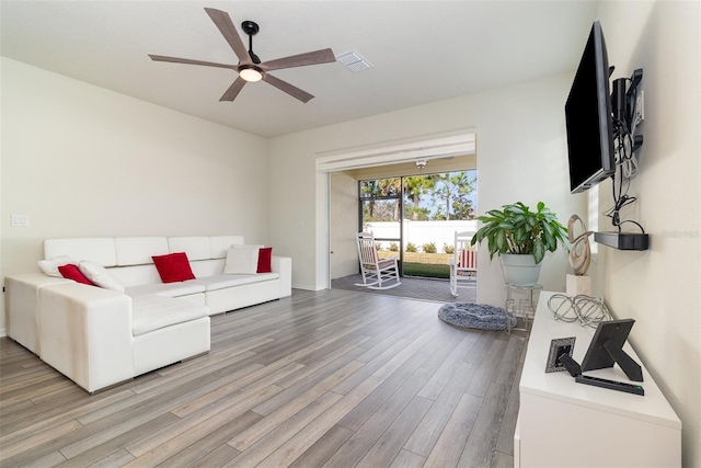 living room featuring ceiling fan and light hardwood / wood-style flooring