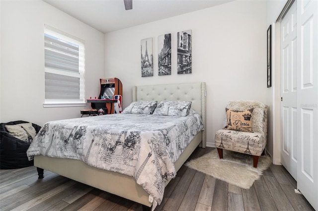 bedroom with a closet, wood-type flooring, and ceiling fan