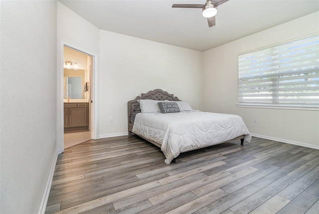 bedroom featuring ceiling fan, ensuite bath, and light hardwood / wood-style floors