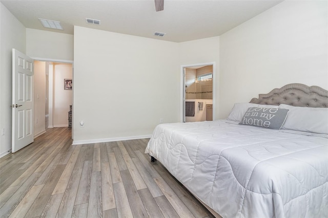 bedroom with ceiling fan, connected bathroom, and light hardwood / wood-style flooring