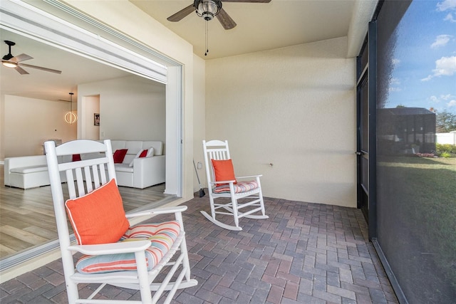 sunroom featuring ceiling fan