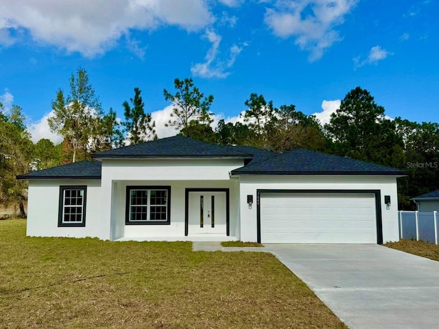 view of front of house featuring a front lawn and a garage