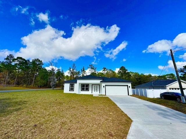 view of front of home with a front yard and a garage