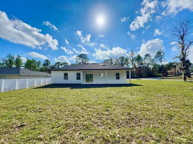 back of property with a lawn