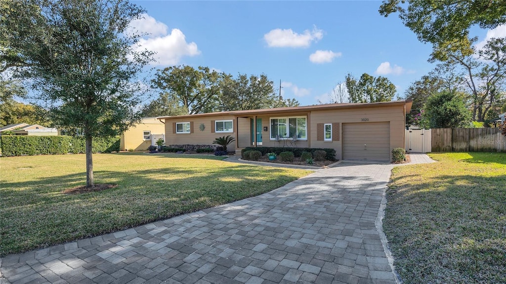 ranch-style house with a front lawn and a garage