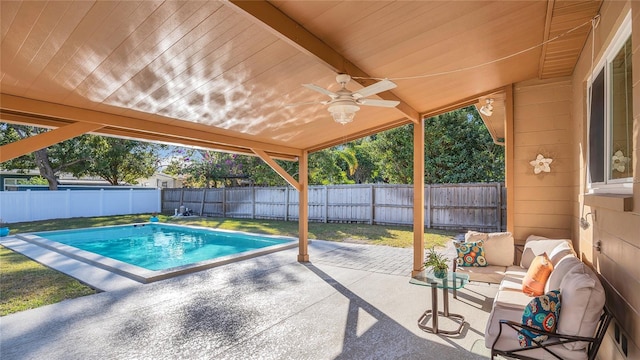 view of swimming pool with a lawn, ceiling fan, an outdoor hangout area, and a patio