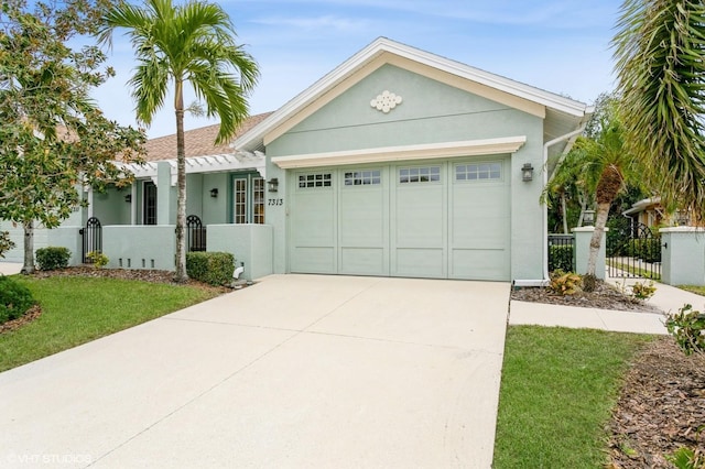 single story home featuring a front yard and a garage