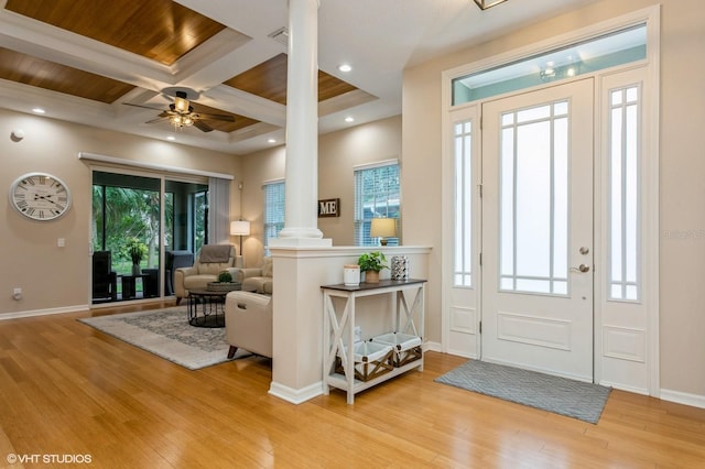 foyer with ornate columns, a wealth of natural light, coffered ceiling, and ceiling fan