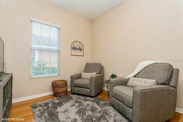 sitting room with a wealth of natural light and hardwood / wood-style flooring