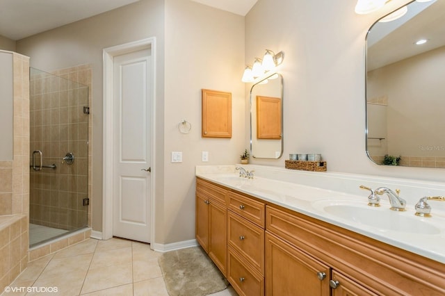 bathroom featuring a shower with shower door, vanity, and tile patterned flooring