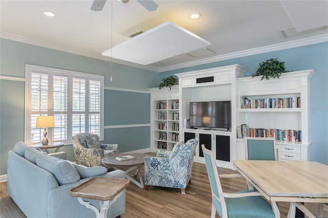 living room featuring ceiling fan, wood-type flooring, and crown molding