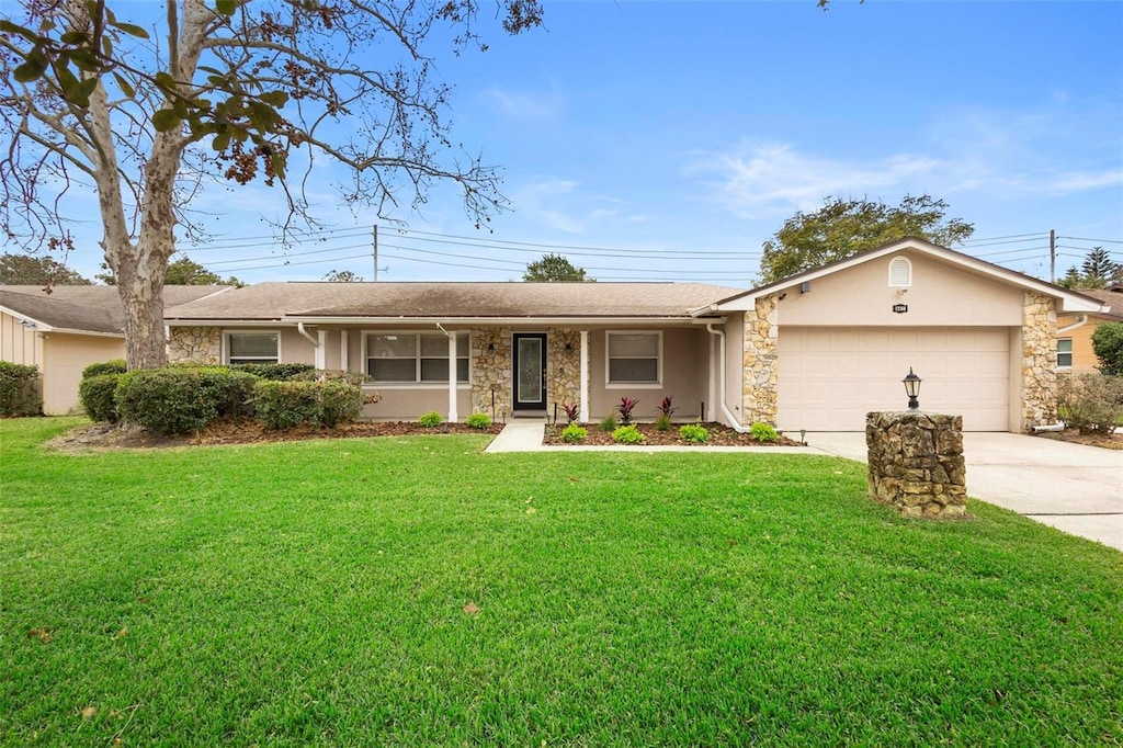 ranch-style home with a garage and a front lawn