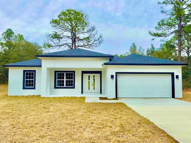 view of front facade with a garage and a front lawn