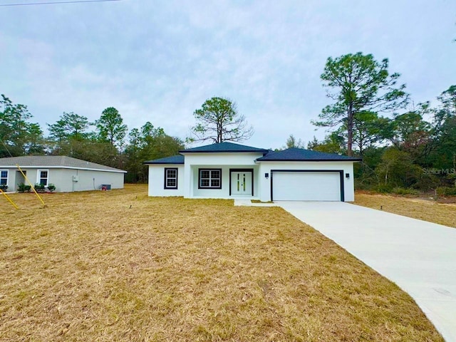 view of front of home with a garage and a front yard