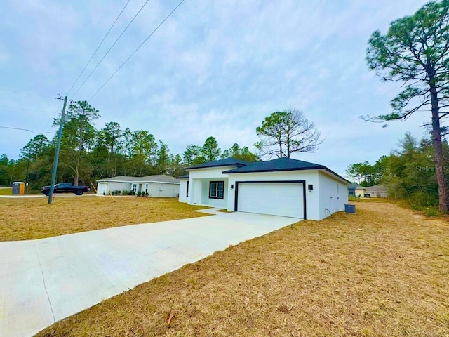 single story home with a garage and a front yard