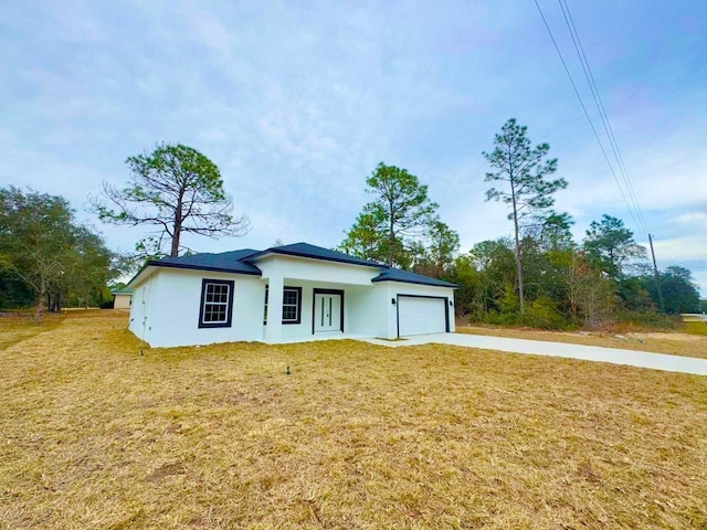 view of front of home with a front lawn and a garage