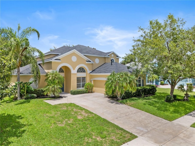 view of front of property with a garage and a front yard